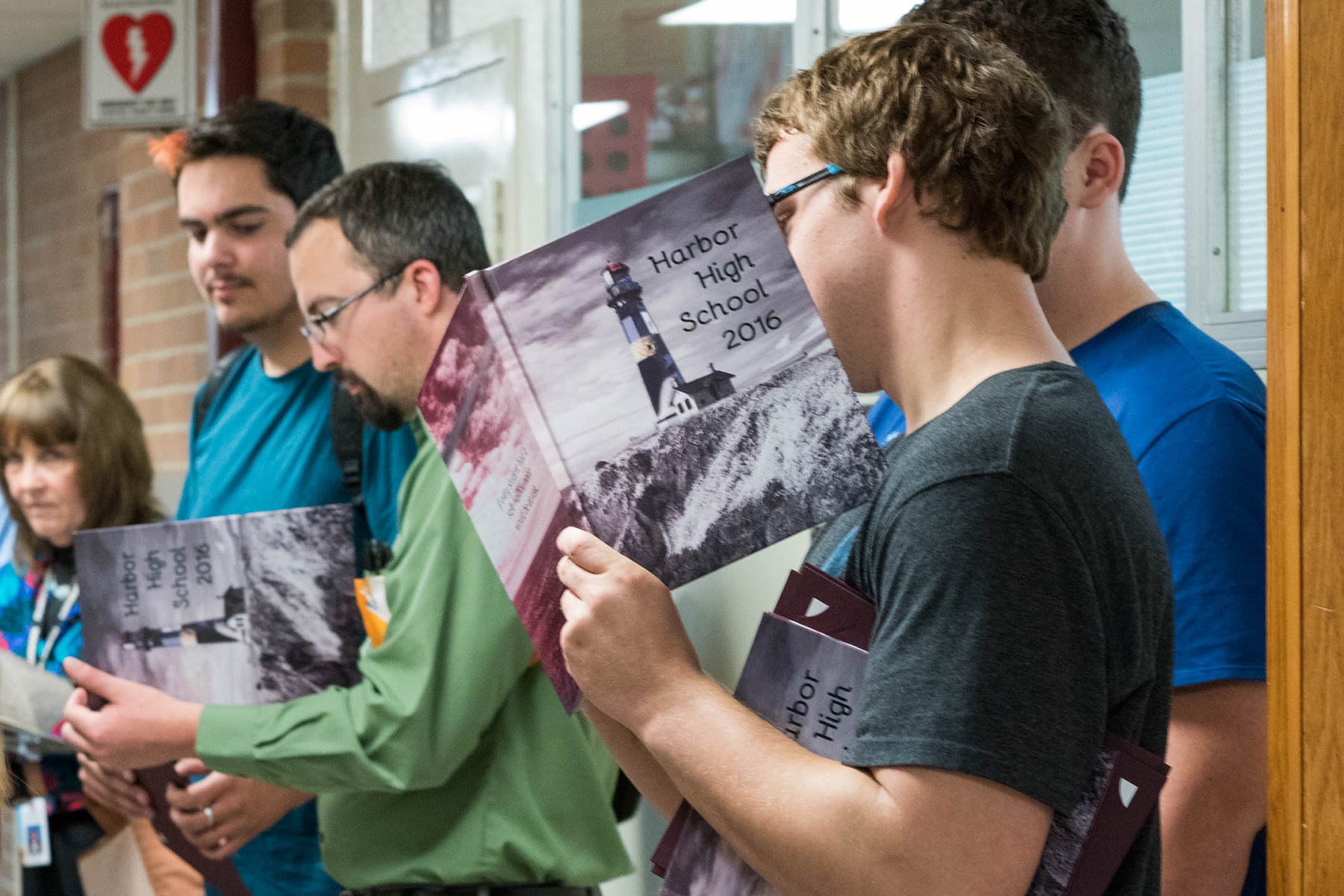 Harbor High School students line up to have their yearbook.
