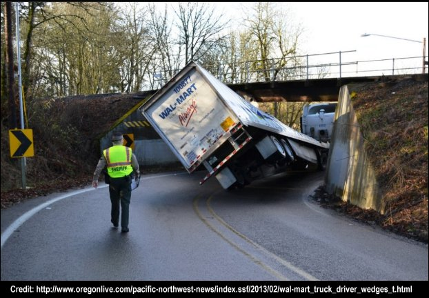 A trucker got a 13'6" truck stuck under a 12&#