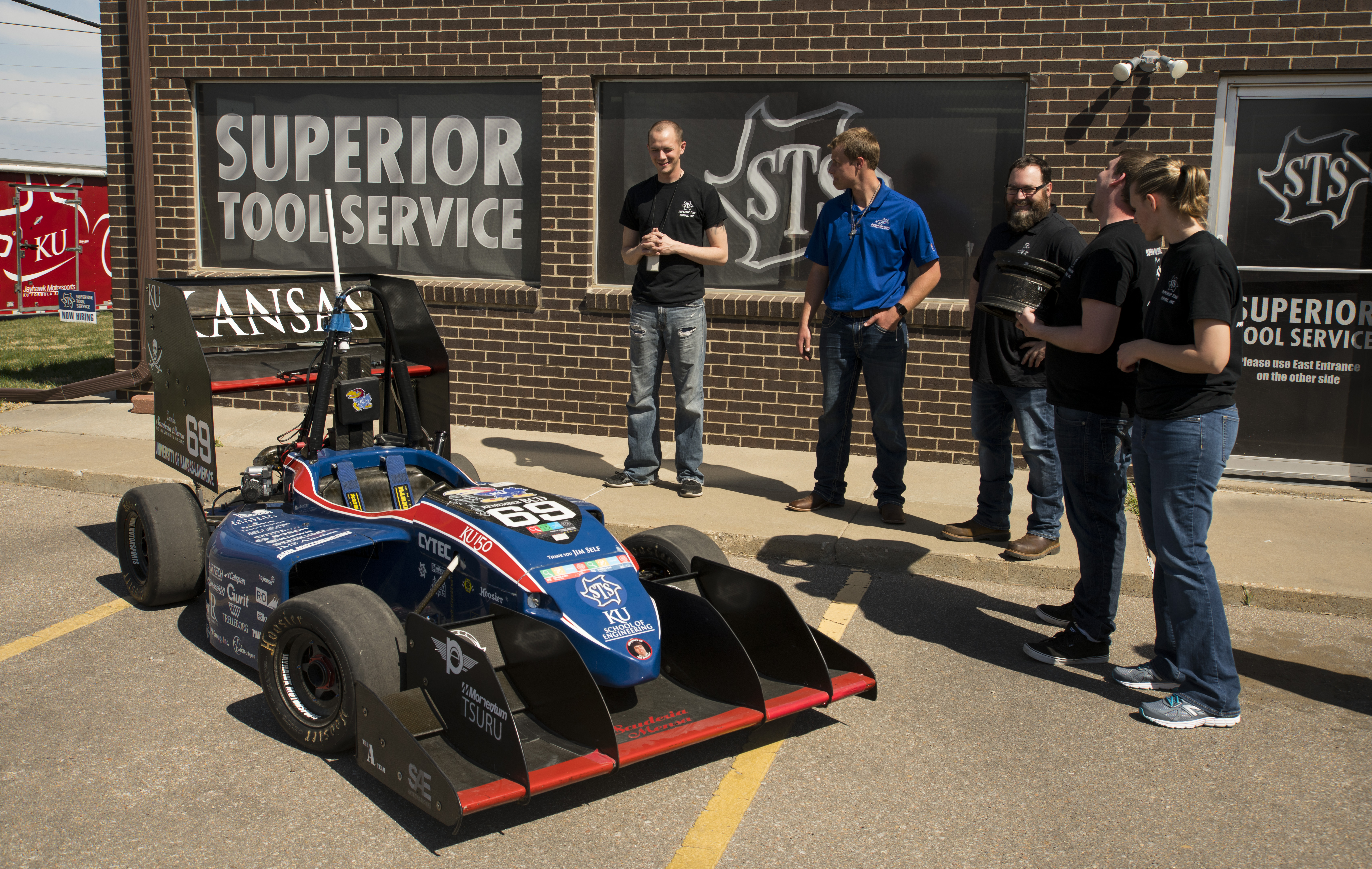Superior Tool Service Staff Look at KU Racecar
