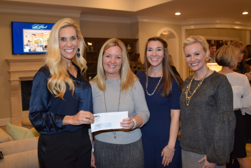 Amazing Spaces presents check to Interfaith of The Woodlands'