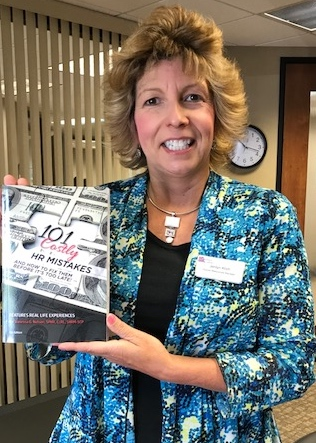 Manager Jerilyn carries my book on her library shelves!'