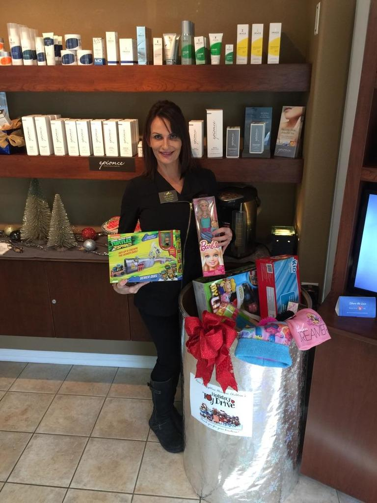 Tiffany holding a toy for the toy drive.