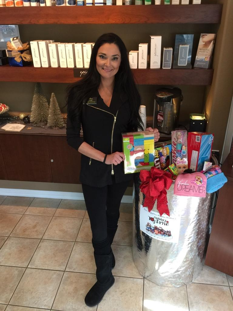 Kimberly posing with a toy for the annual toy drive.