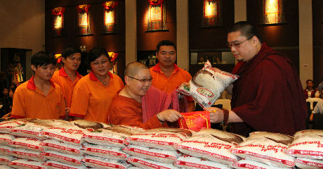 H.E. Tsem Rinpoche distributing food to NGO&rsquo;s and'