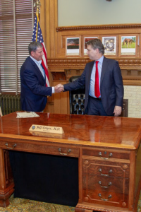 Jason McCracken (left), Governor Colyer (right)