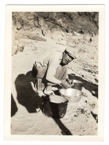 In this photograph, boatman Owen Clark cooks dinner for the