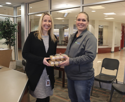 STORExpress employees bringing muffins to a local school.'