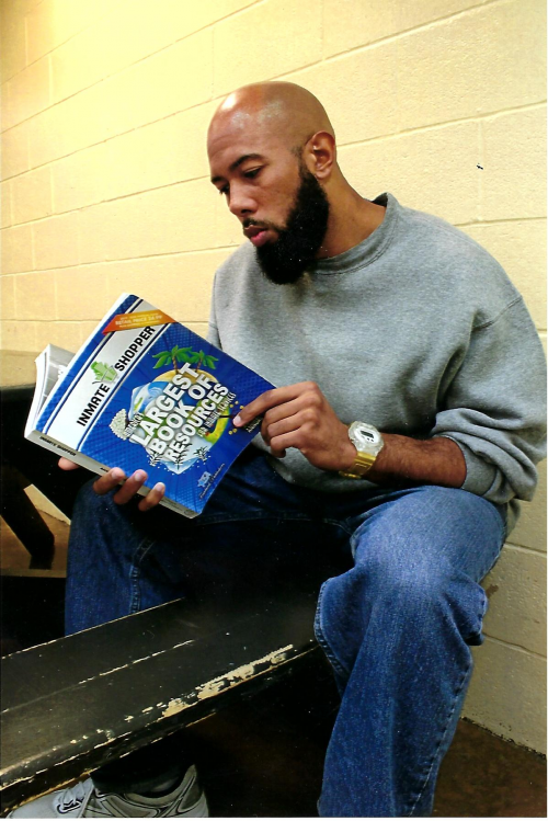 Inmate reading inmate resource book by Freebird Publishers'