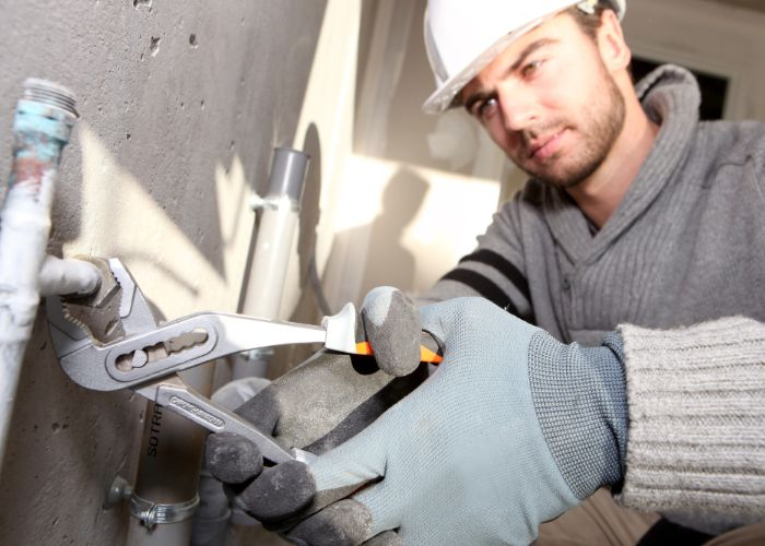 Plumber fixing a pipe'