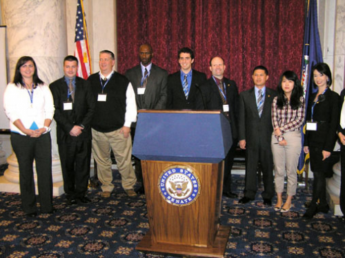 Student presenters pose at the podium at the 2011 Convention'
