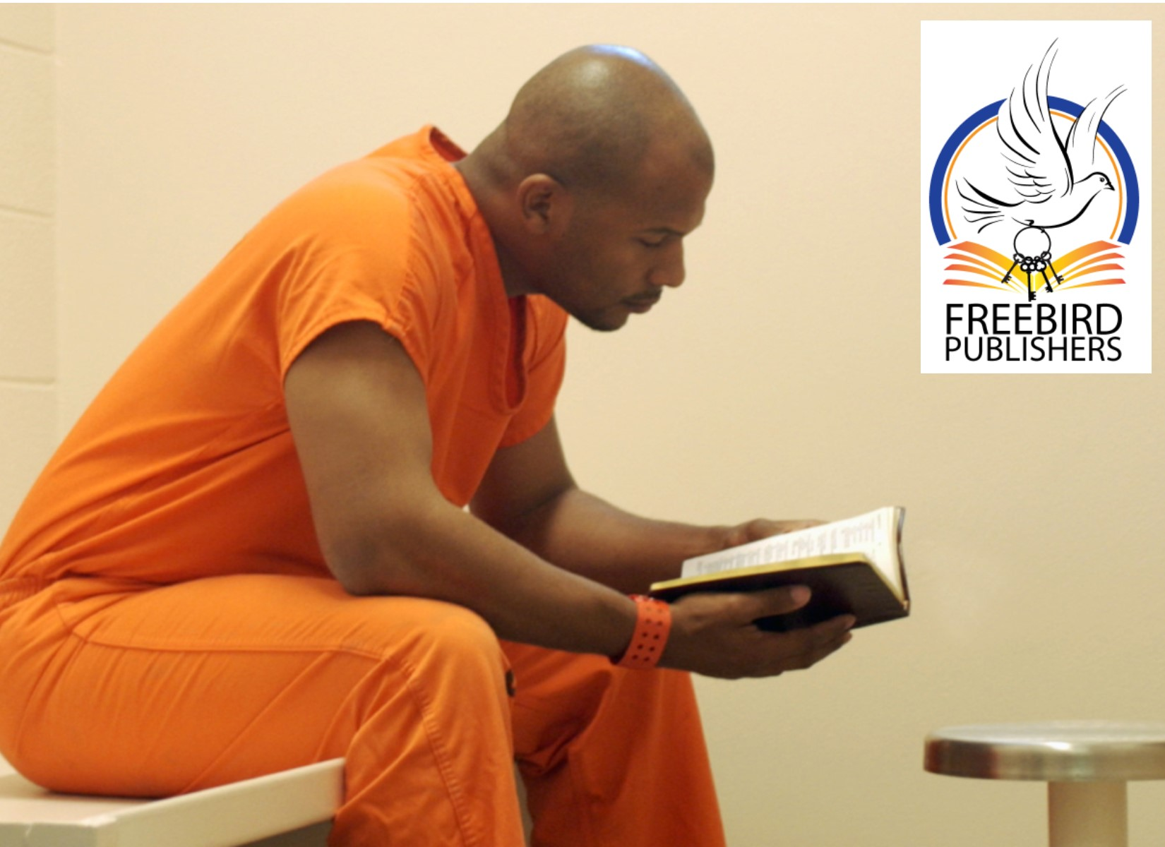 Inmate reading Freebird Publishers Book'