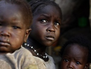 Girls wait for medical aid in Bram village in the Nuba Mount'