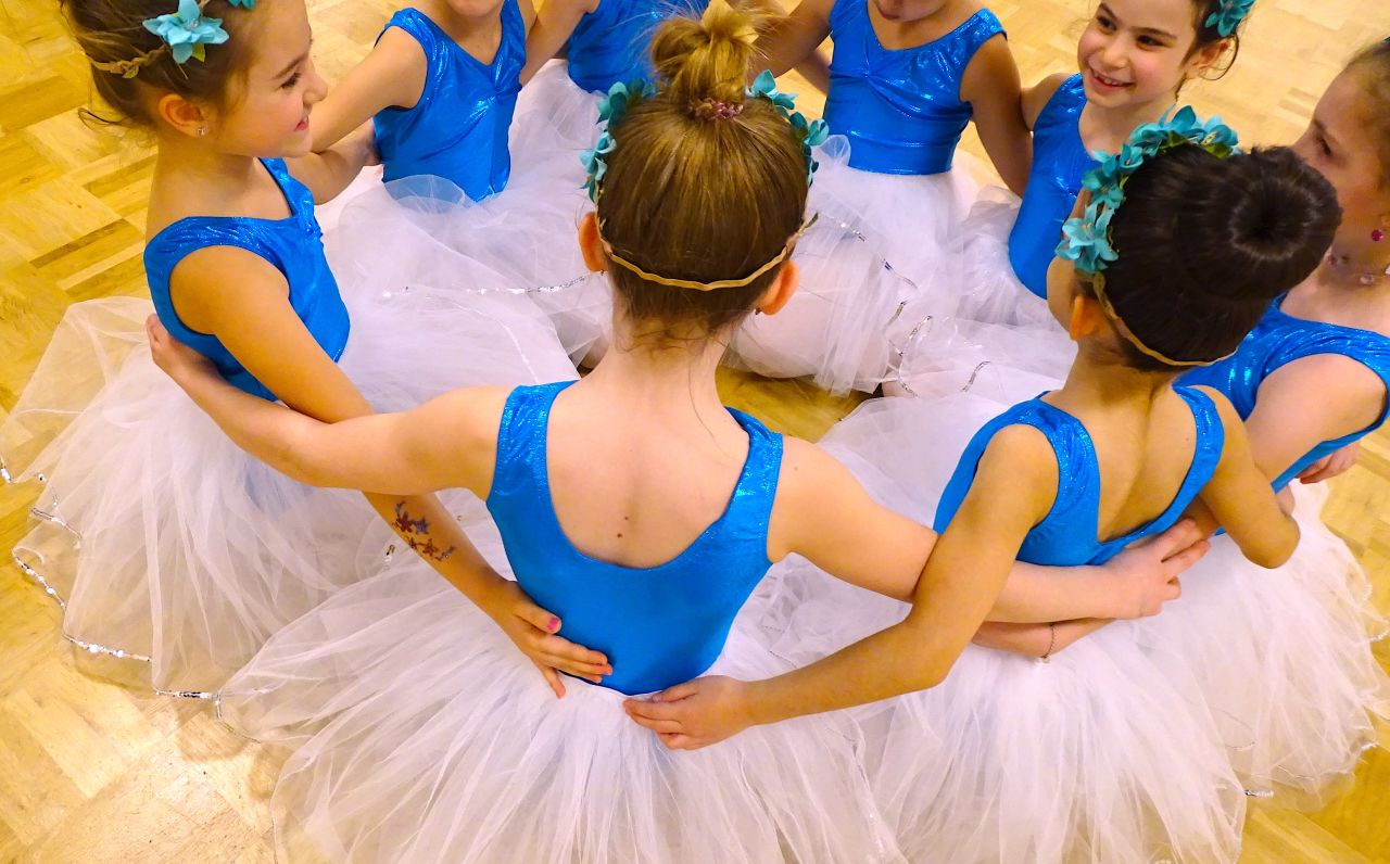Ballet students in a circle at the East Ballet Studio'