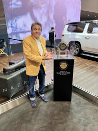 Gary Barbera pictured with JD Power Award and Grand Wagoneer