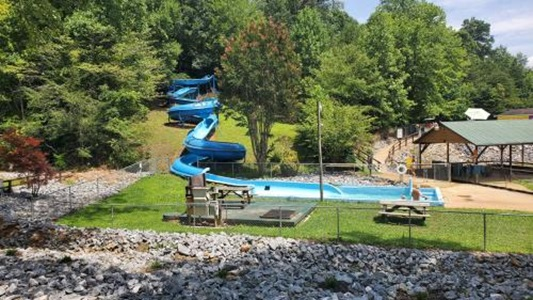 Company Logo For Spacious Skies Campgrounds - Hidden Creek'