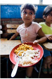 A young Nicaraguan girl shows the food she received.'