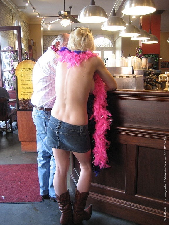 Topless woman in a New Orleans coffee shop during Mardi Gras'