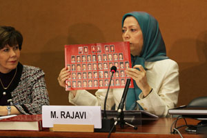 Maryam Rajavi Holding a Poster Of Ashraf Martyrs Photos