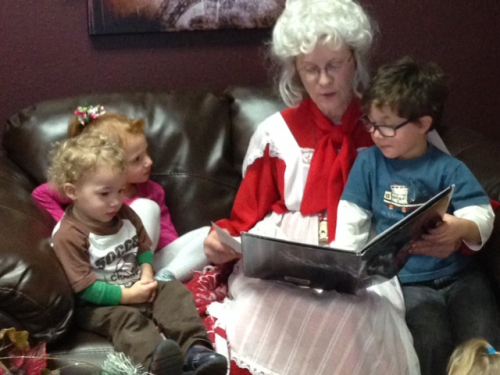 Mrs Santa reading to children'