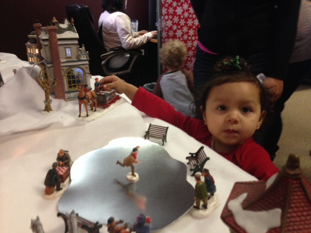 Children playing with Christmas village set'