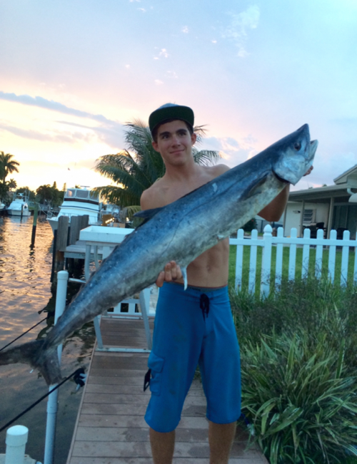 Allan Escuage poses with a 33-pound kingfish he caught in to'